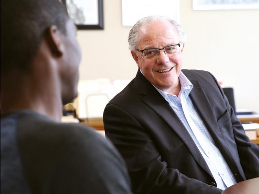 Dr. Gamble smiling with male student