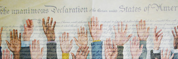 hands raised in from of US constitution