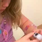 girl checking her blood sugar