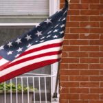 American flag hanging in front of a house