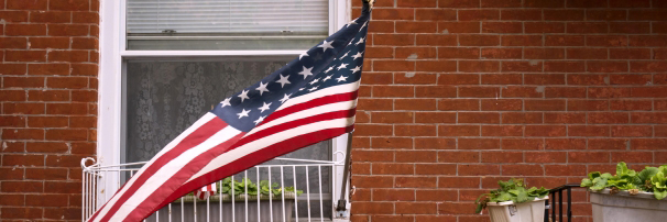American flag hanging in front of a house
