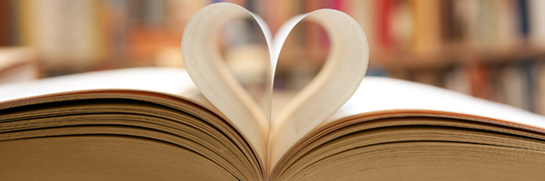Book page in heart shape with library background