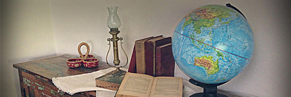 globe, books and light on table