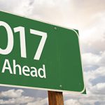 2017 Just Ahead Green Road Sign Against Dramatic Clouds and Sky.