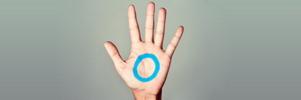 blue circle painted on the palm of a hand