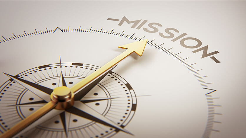 an arrow on a compass pointing towards the words mission