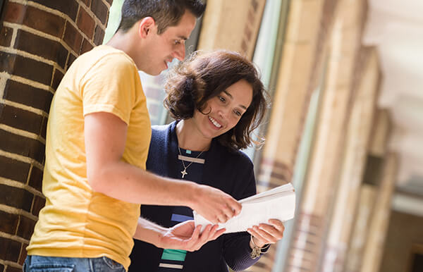 two students looking at a document