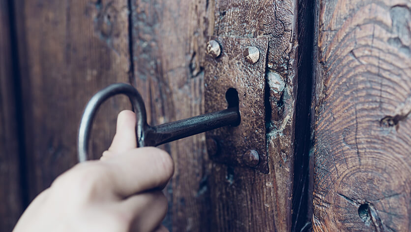 opening a wooden door with a skeleton key