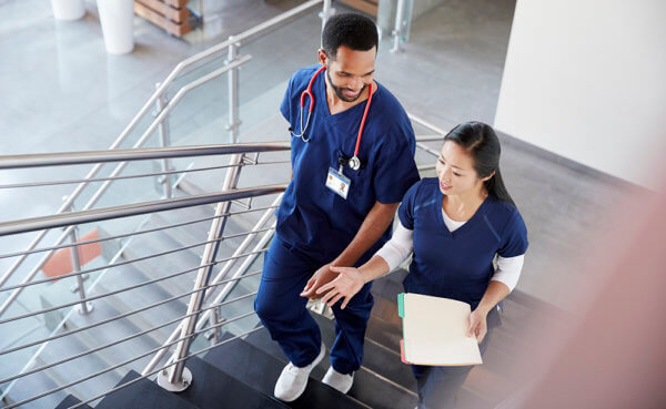 two nurses walking up stairs