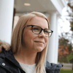 female student in front of the McAuley building