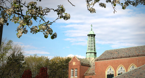 Marian Hall steeple surrounded by spring blossoms