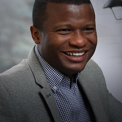 Man smiling with checkered shirt on