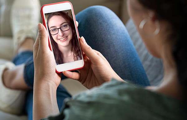 Young woman using smartphone for video call