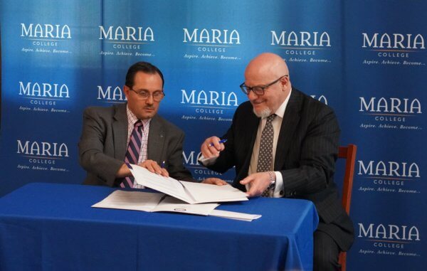 Greg Sorrentino and Dr. Thomas Gamble sign paperwork to endow scholarship.