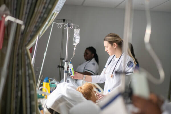 Nursing students at Maria College receive hands-on training in a simulated clinical environment, building essential patient care skills.